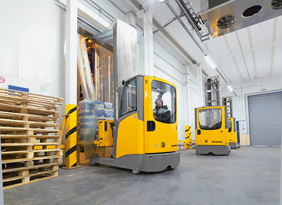 Jungheinrich Sit Down Moving Mast Reach Trucks in Use in a Warehouse