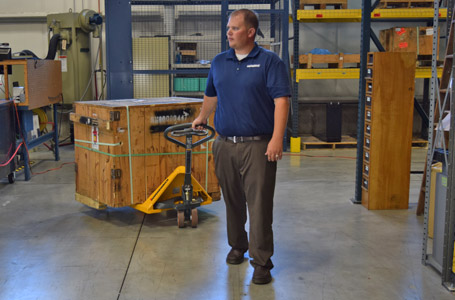 Man Pulling a Crate on a Jungheinrich Hand Pallet Jack